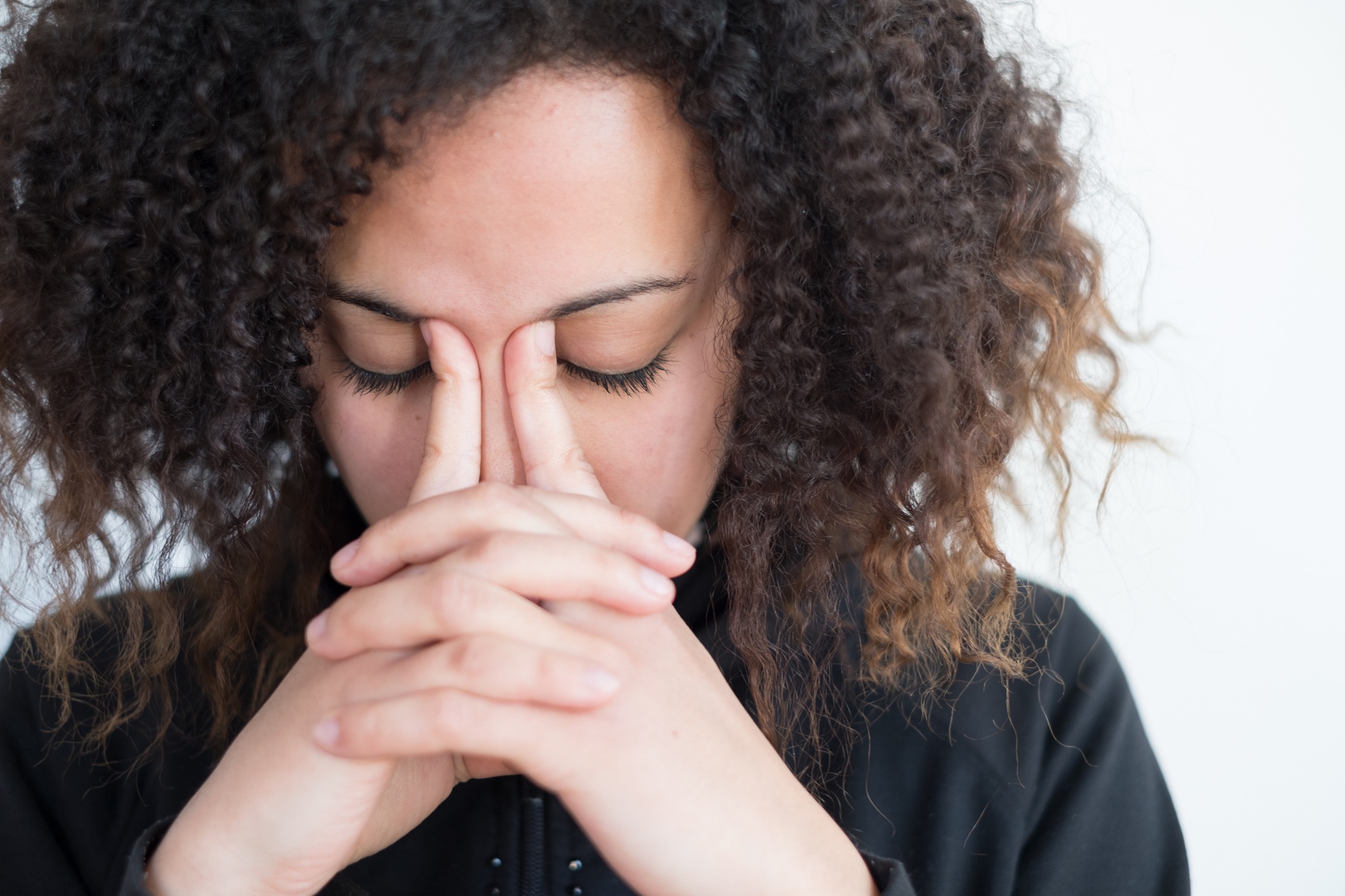 women pinching forehead in stress