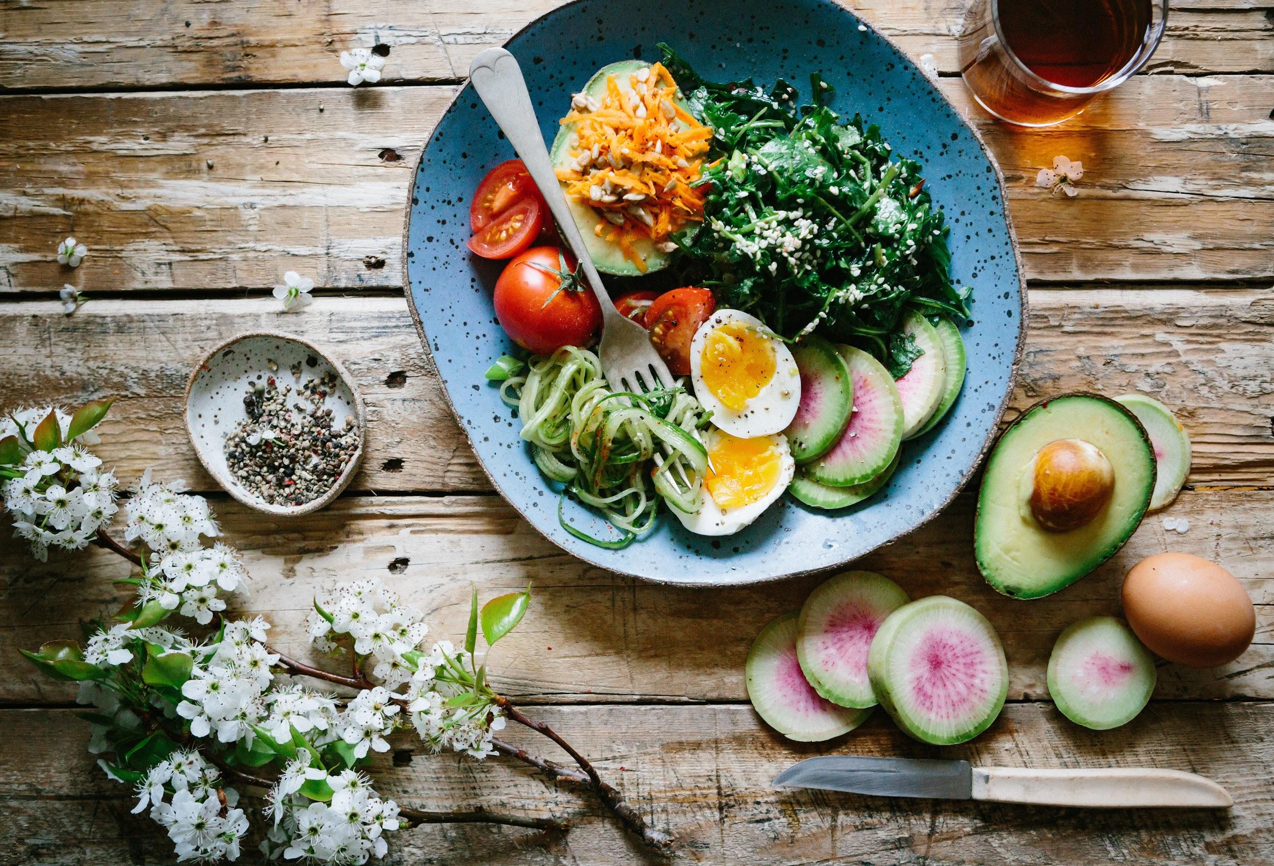 Beautiful bowl with eggs and avocado on rustic wood background